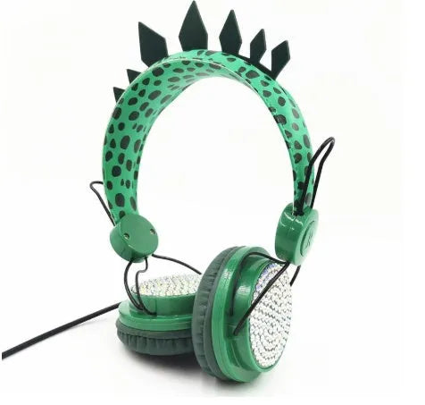 Green dinosaur children's headset with soft earmuffs and 3.5mm plug on a plain background