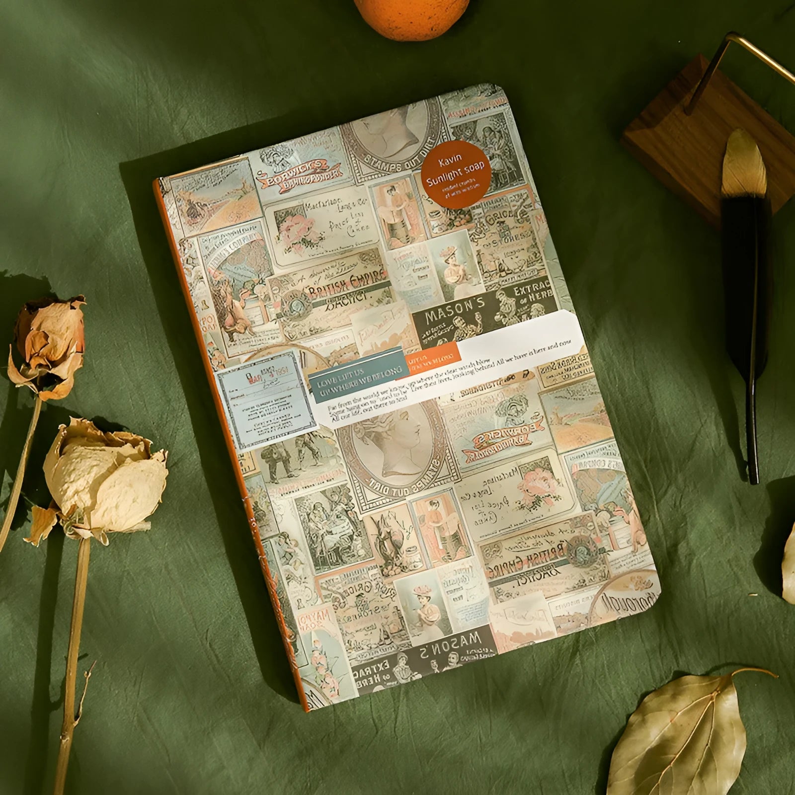 A5 kraft paper mood notebook open on a page, showing its European retro style and colour options of blue, coffee, and red.