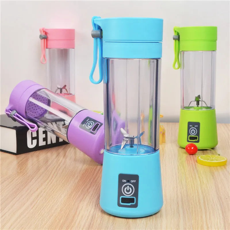 Pink mini USB electric fruit juicer with carrying rope on a kitchen countertop.