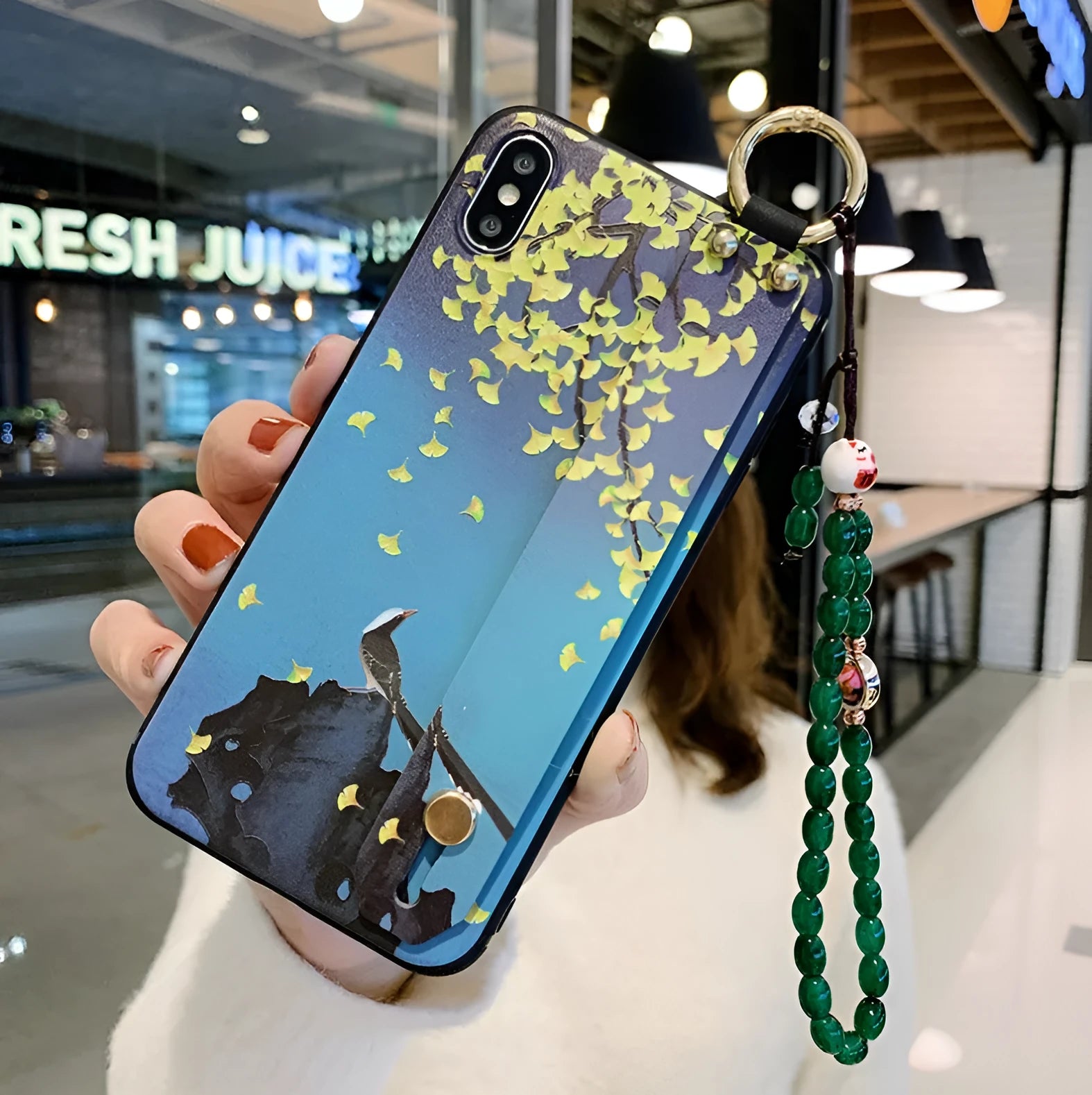 Rose flower design iPhone case with a white wrist strap attached, shown on an iPhone 11.