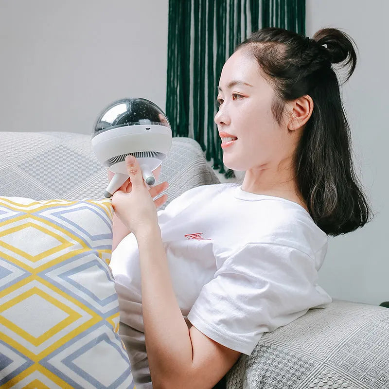 Black rotating starlight projection lamp projecting cartoon stars onto a ceiling