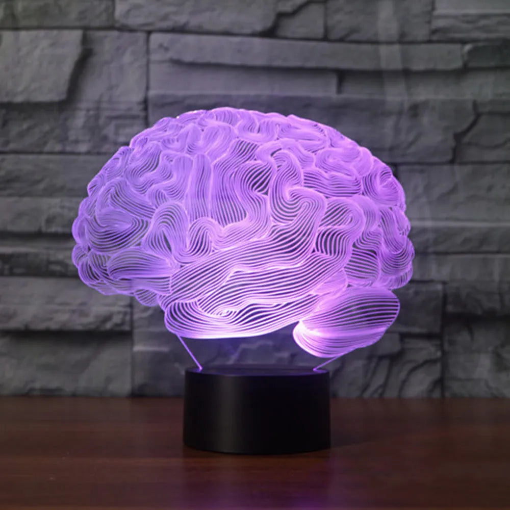 3D acrylic brain hologram LED desk lamp with black base and remote control on a wooden table.
