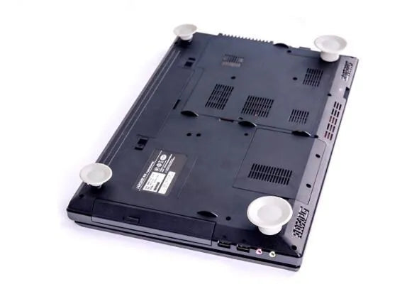 Four grey plastic laptop cooling pads, two large and two small, on a flat surface.
