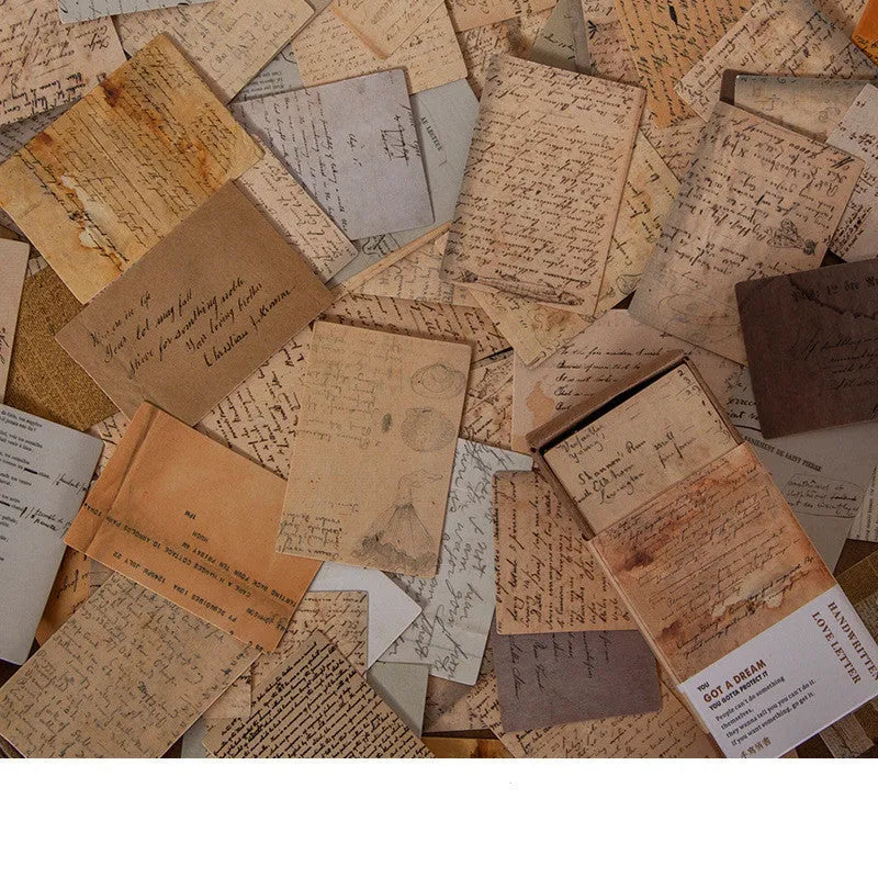Pack of 100 small double-sided retro paper notes in various vintage colours on a wooden surface.