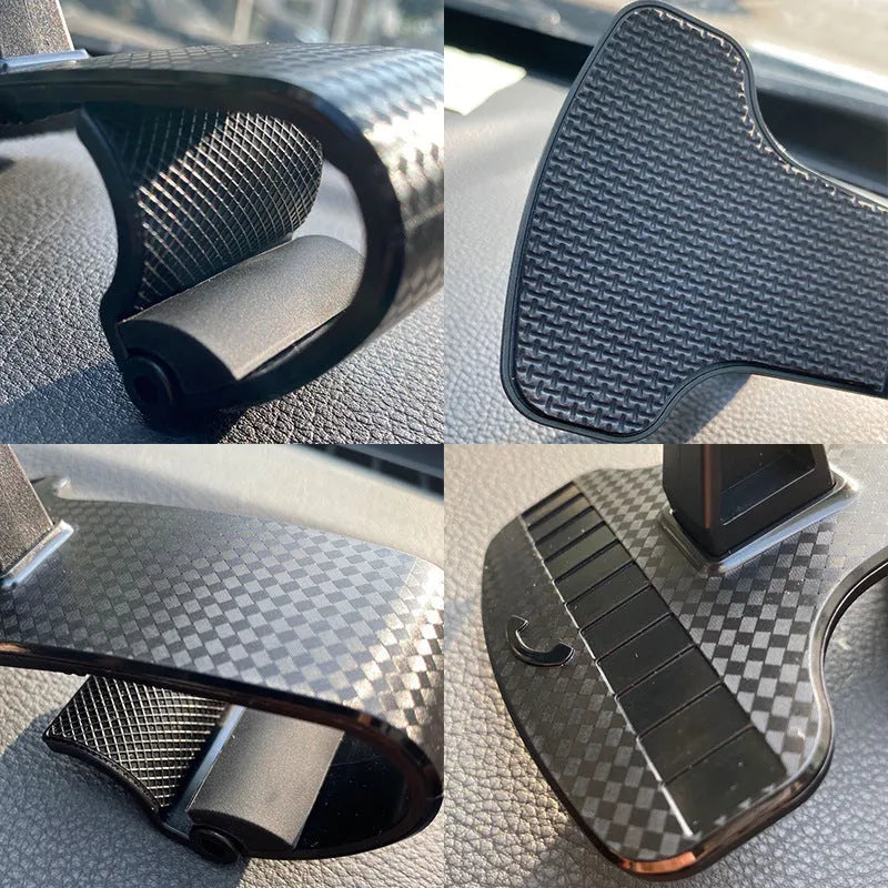 Black adjustable car phone holder with 360-degree rotating head on a car dashboard.