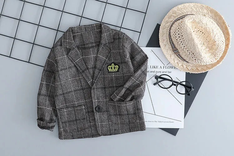 Grey cotton three-piece suit for a toddler boy on a hanger.