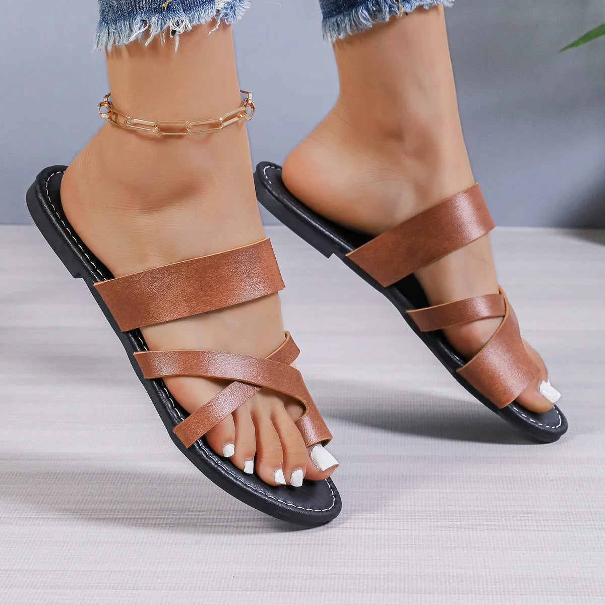 Casual round head beach slippers in black with a breathable hollow out design and rubber sole.