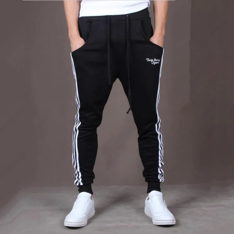 Men's straight leg cotton casual trousers with three-bar side stripe in grey, black, and navy