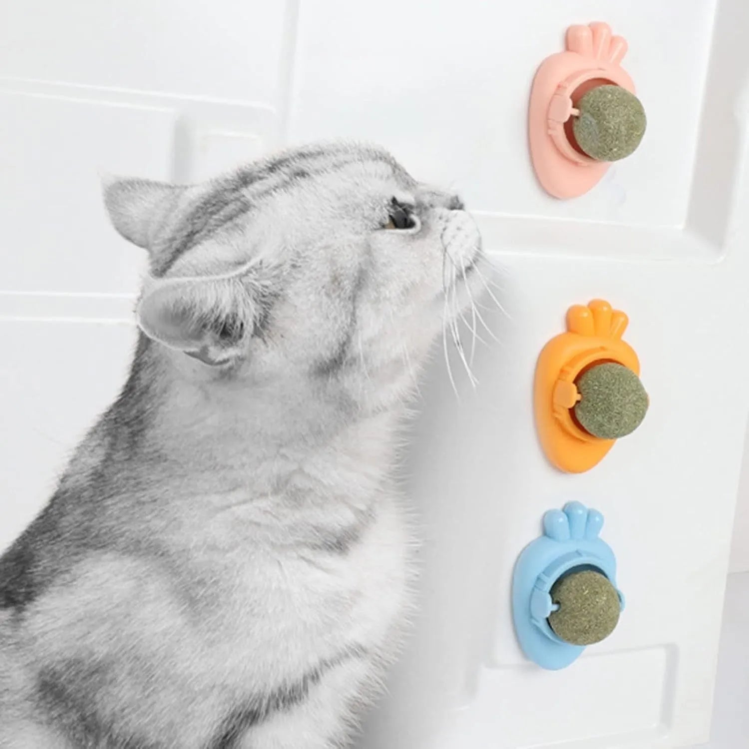 Blue carrot-shaped catnip toy with self-adhesive sticker for wall mounting and teeth cleaning