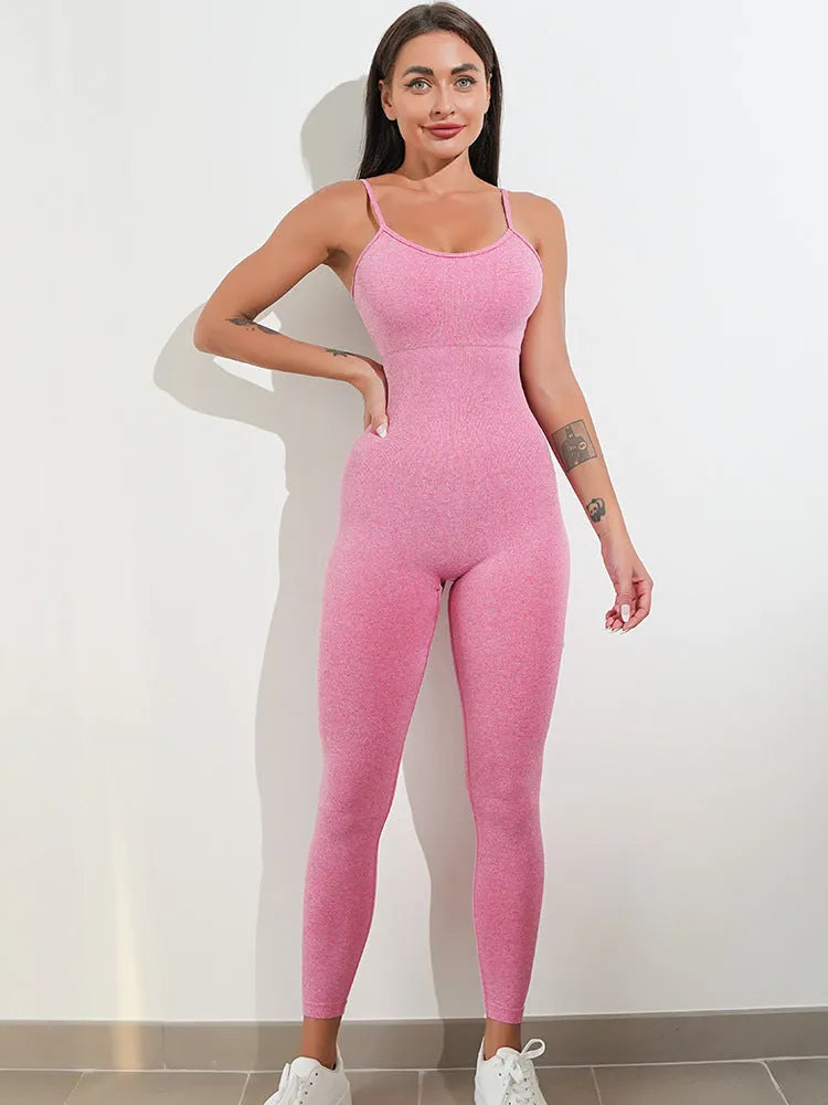 A woman wearing a black sleeveless unitard jumpsuit with spaghetti straps, showcasing its tight fit and backless design.