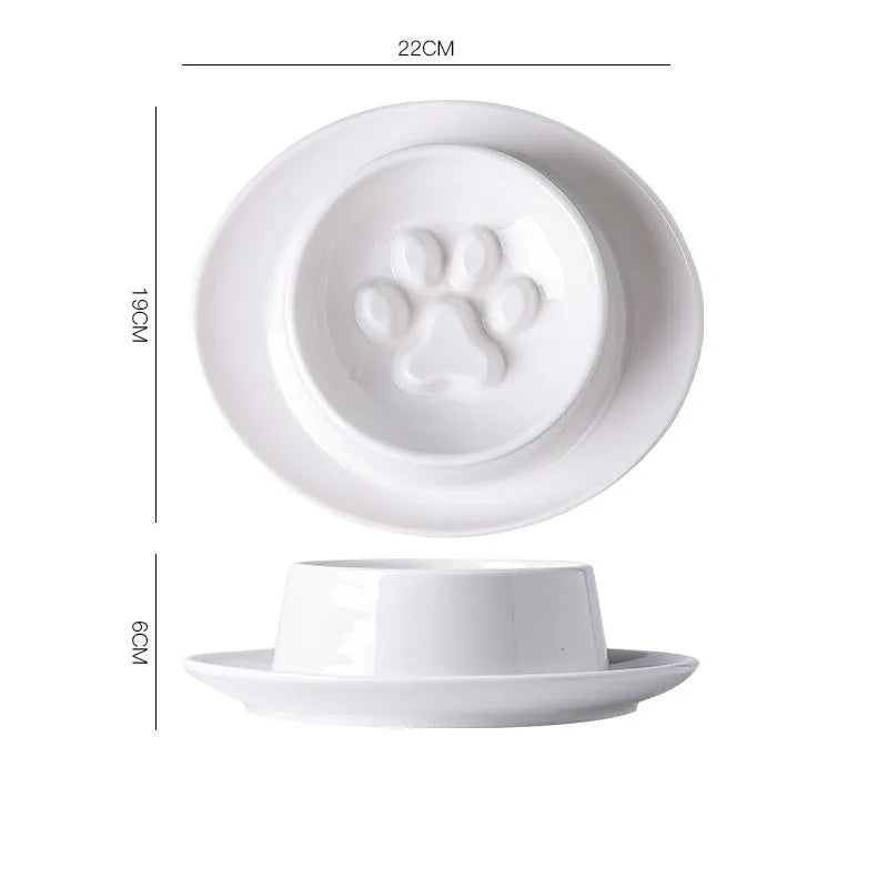 Green ceramic slow feed pet bowl with internal ridges and a raised centre on a white surface.