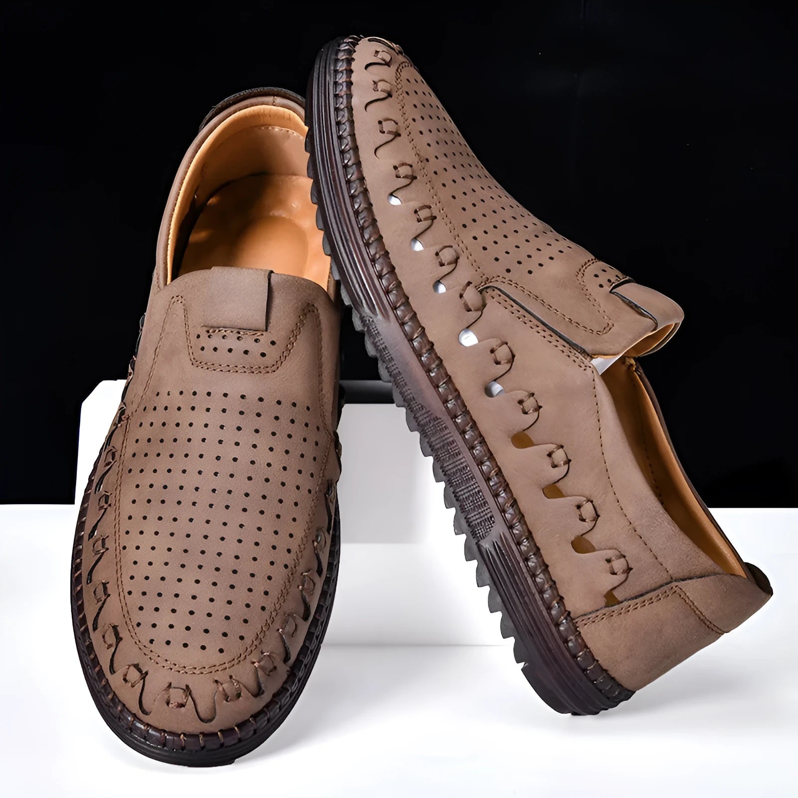 Men's brown slip-on casual shoes with round toe and hollowed-out pattern detailing