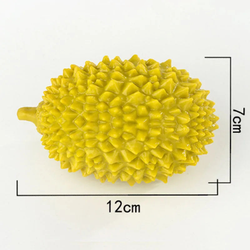 Durian-shaped dog chew toy in yellow with squeaker and tooth cleaning ridges