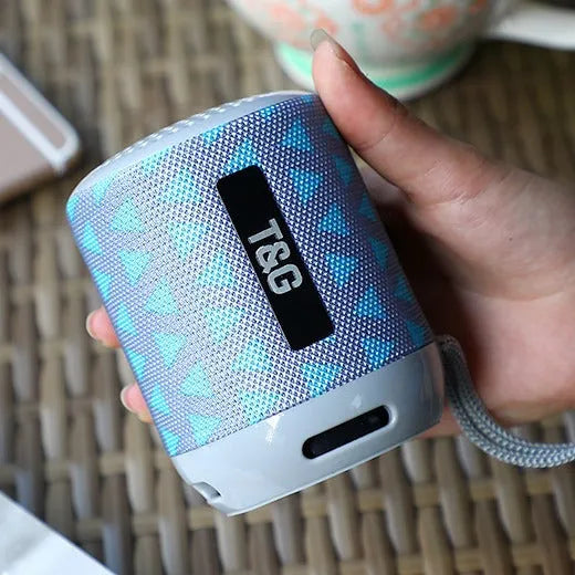 Wireless Bluetooth speaker in black, compact portable design with USB port and fabric grille