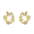 Copper geometric ellipse drop earrings with electroplated 42 gold finish on white background