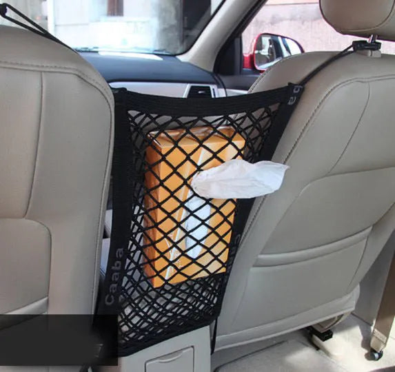 Black elastic nylon car pet fence isolation net installed on middle seat with hooks.