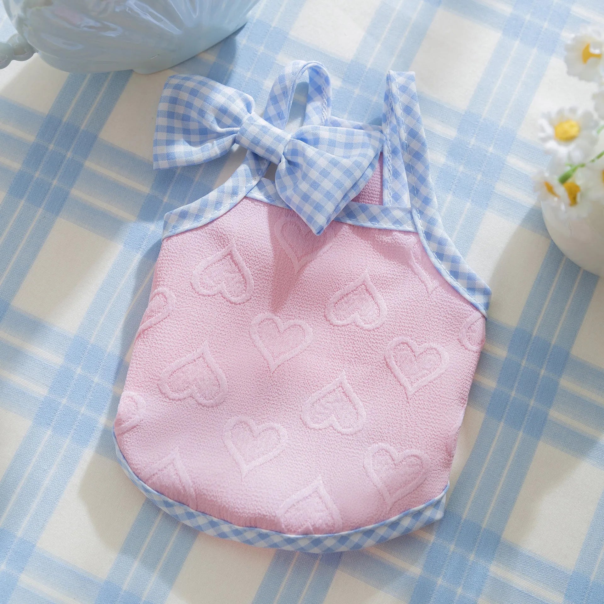 Small dog wearing heart bow suspenders vest in elastic polyester pet clothing