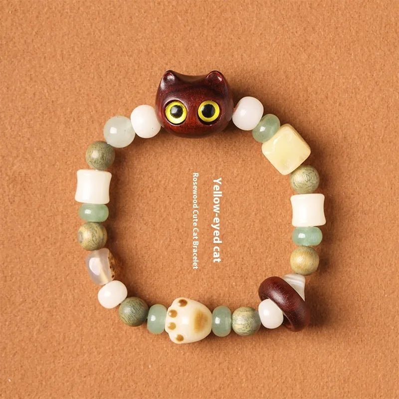 Hand-woven multi-treasure bracelet with Bodhi seeds, jade, and wood beads featuring a cat's paw charm.