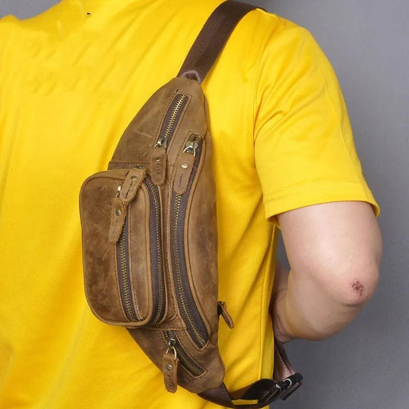 Brown leather messenger bag with single shoulder strap showing front pocket and dimensions