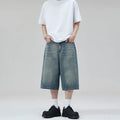 Men's loose straight denim shorts in light blue, cropped length, flat lay