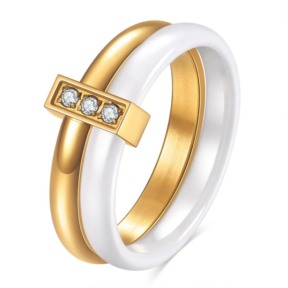 Glossy black ceramic women's ring with silver stitch-inlaid zirconium detail on a geometric band.