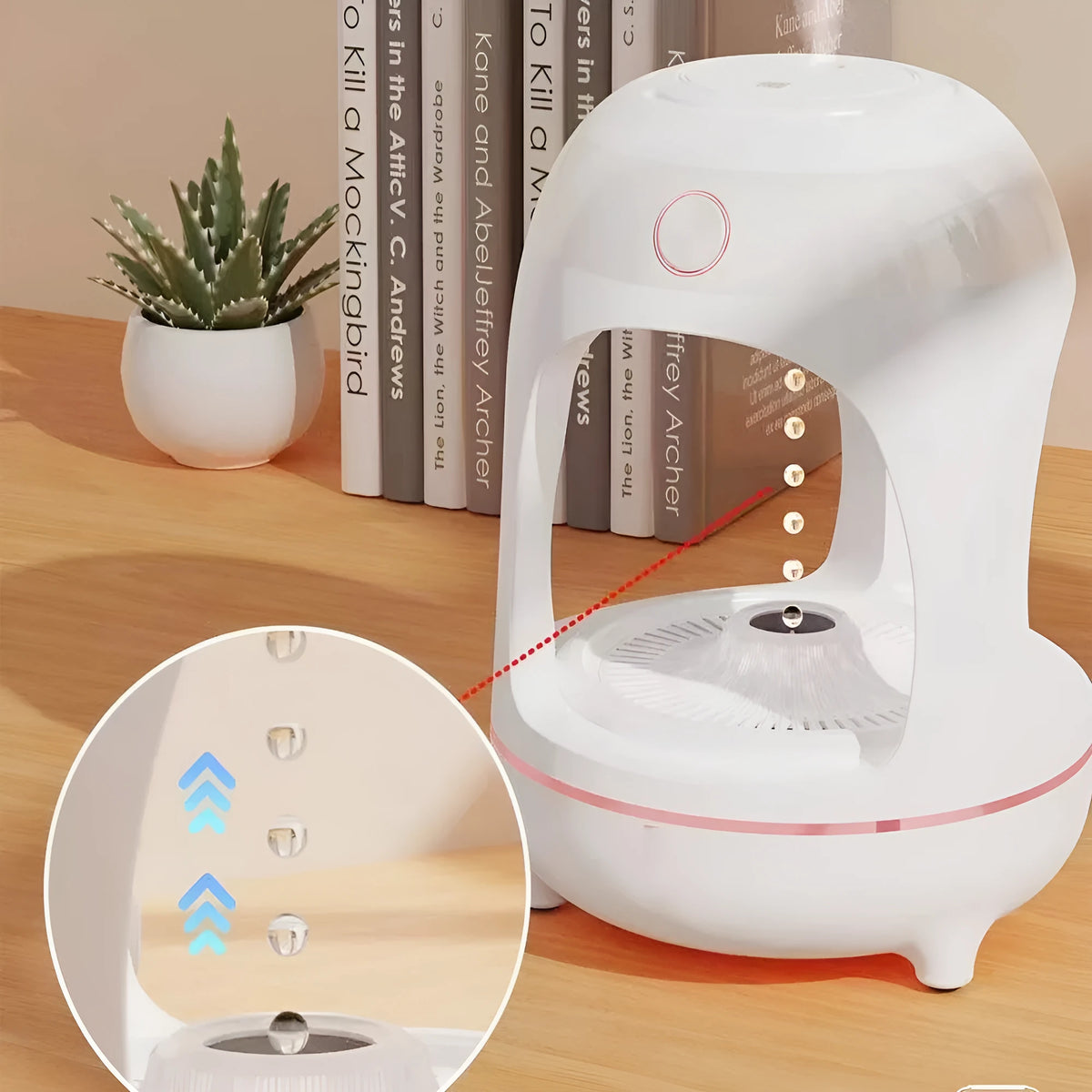Rose gold and white levitating water drops ultrasonic humidifier and LED night light on a desk