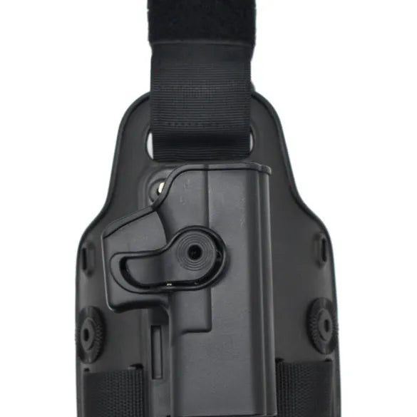 Green tactical plastic leg holster attached to a waist plate, showing quick-pull opening.