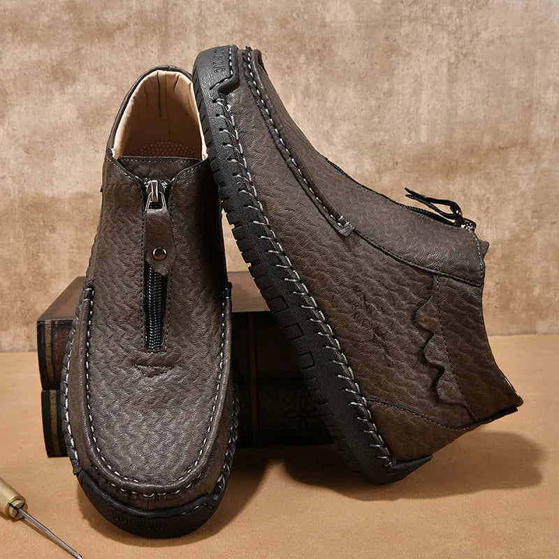 Men's black slip-on loafers with round toe and visible stitching on a rubber sole.