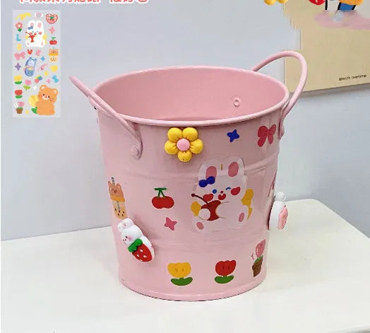 Round metal desk pen holder with iron art design in colour options including pink, green, red, white, and yellow
