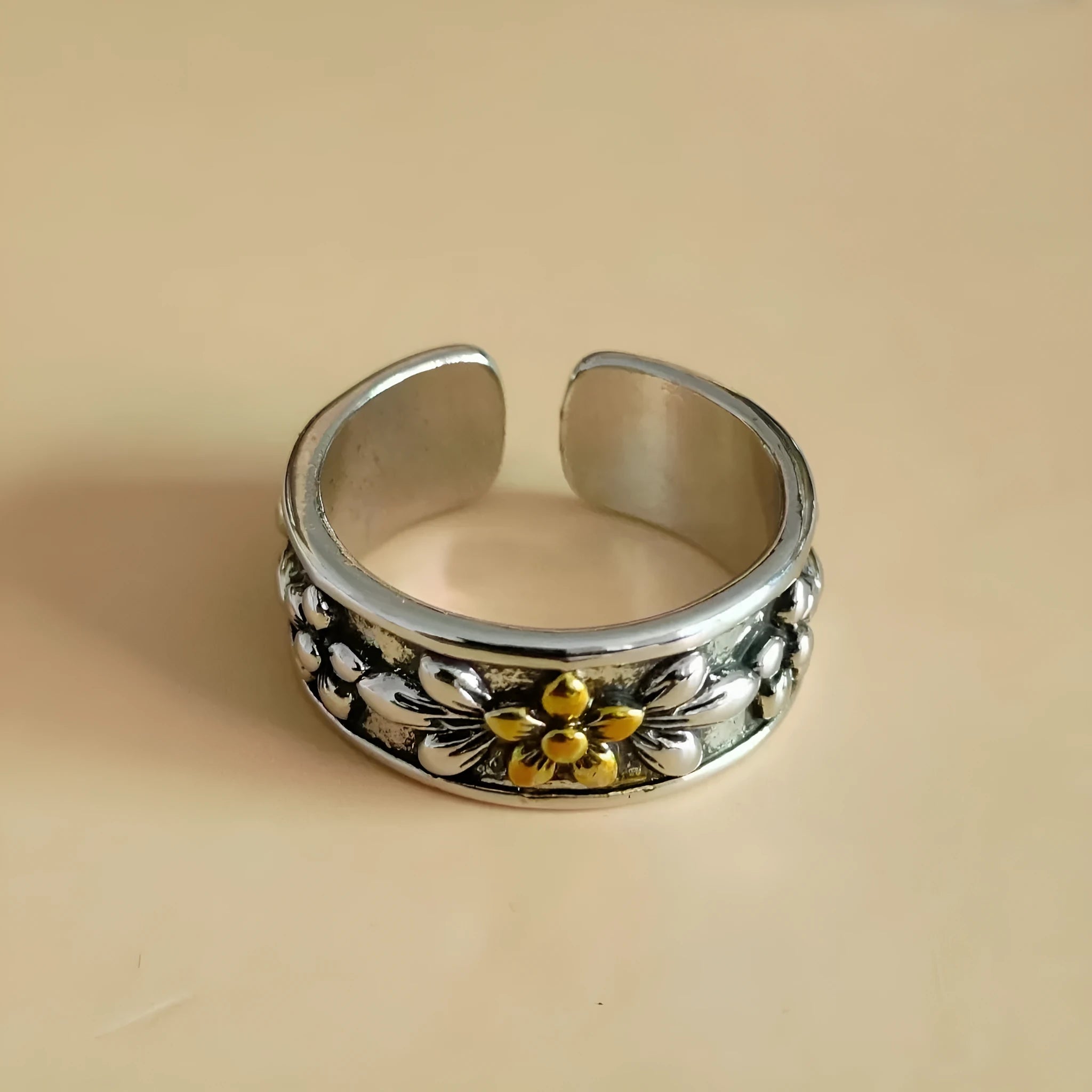 Vintage antique silver gold flower open ring with adjustable band and floral camellia motif on light background