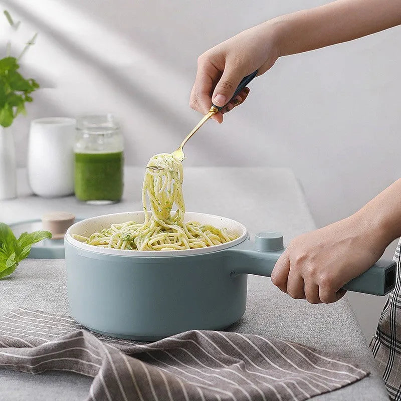 White and green multi-function electric cooking pot with control panel, 600W power, and compact design.