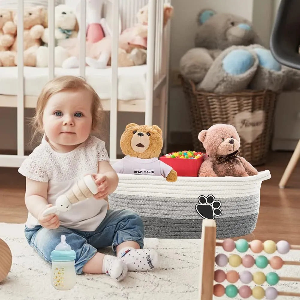 Light beige handmade woven cotton rope storage basket with wooden handle.