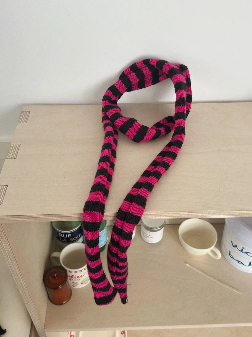 Black and white striped thickened wool decorative thin scarf on neutral background, unisex yarn knit style