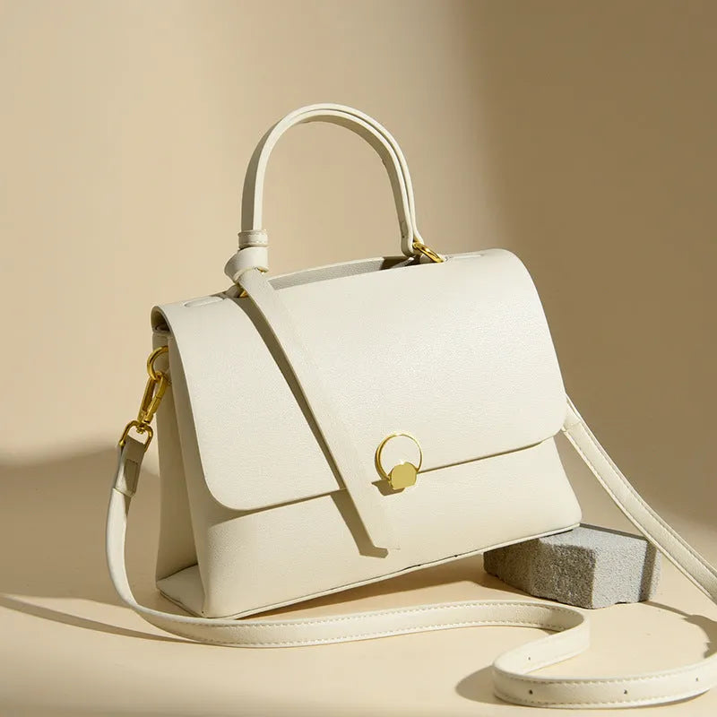 Soft PU cross-body handbag in beige, square vertical shape with sewing line detail, on white background