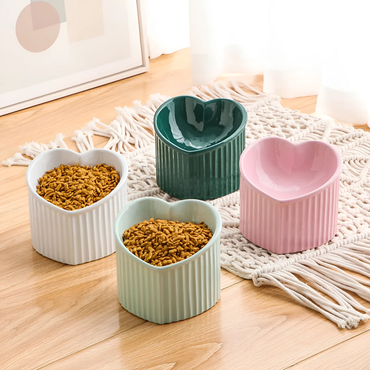 Close-up of a pink ceramic pet bowl with a slanted rim, showing the inclined feeding surface against a clean background.