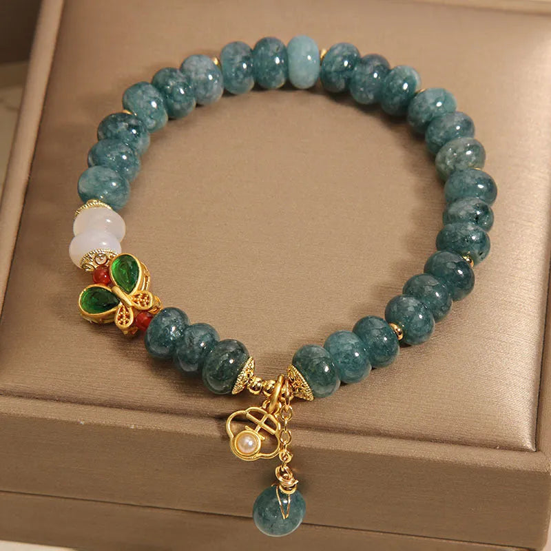 Blue water jade abacus bead and white agate bracelet with alloy and rhinestone details for women.