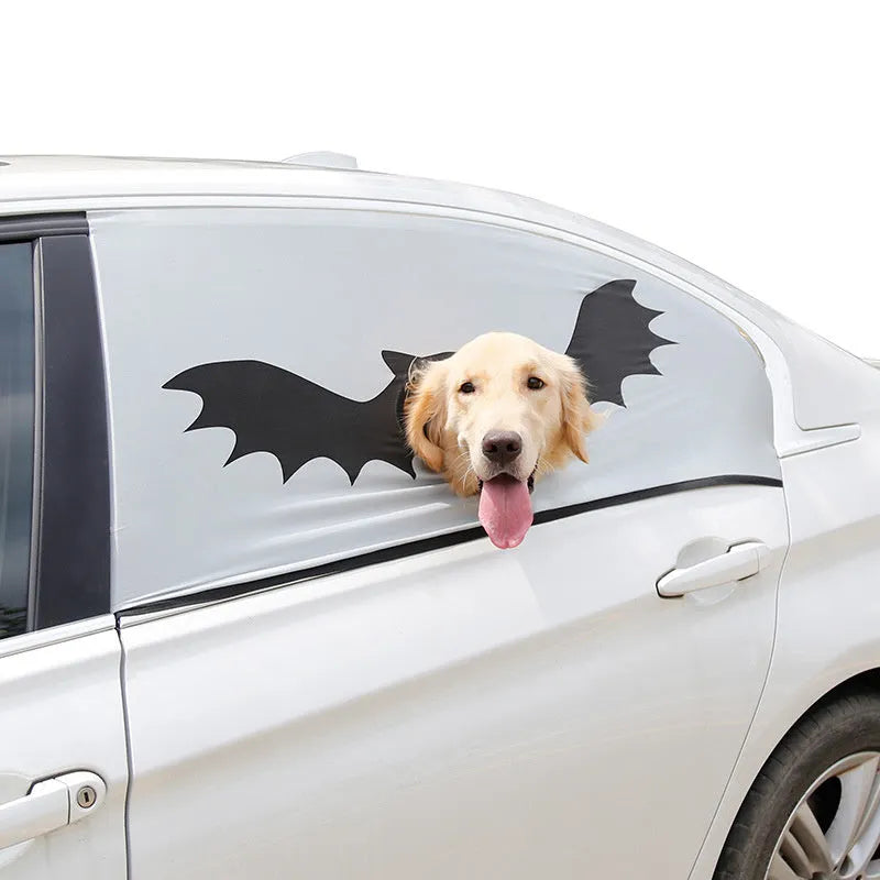 Grey car sun shade curtain with bat pattern and central head hole for dogs, installed on a car window
