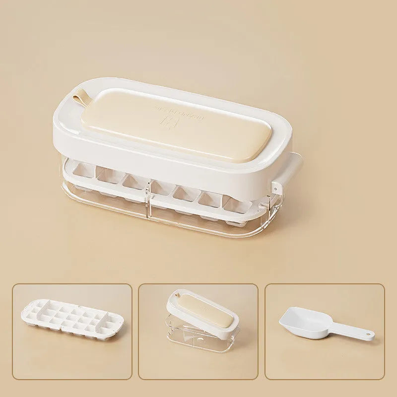 Yellow lever-action ice cube tray with high-capacity grid and attached ice shovel on a blue background.