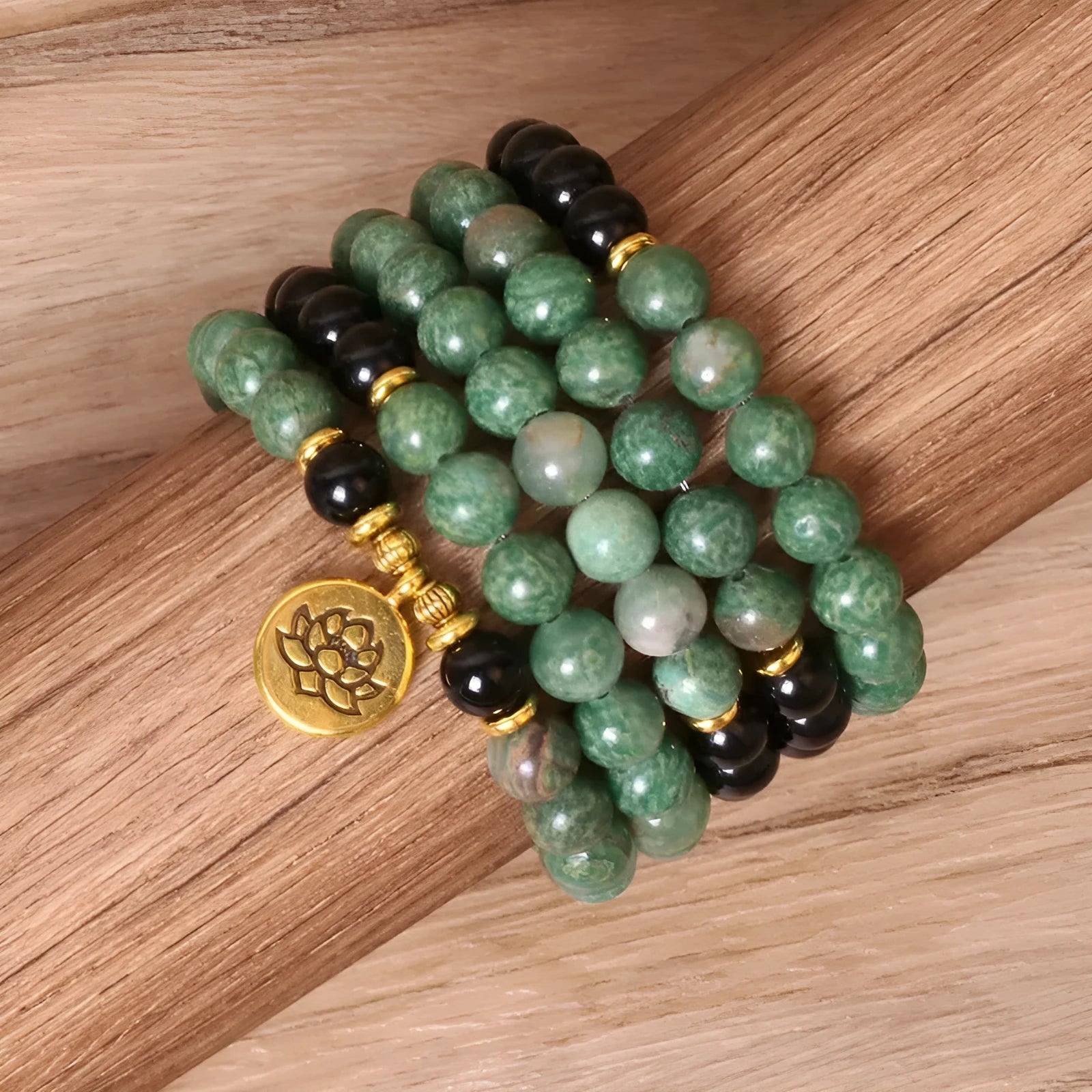 Green and black elastic beaded alloy bracelet on a wrist, showing its natural style and length.