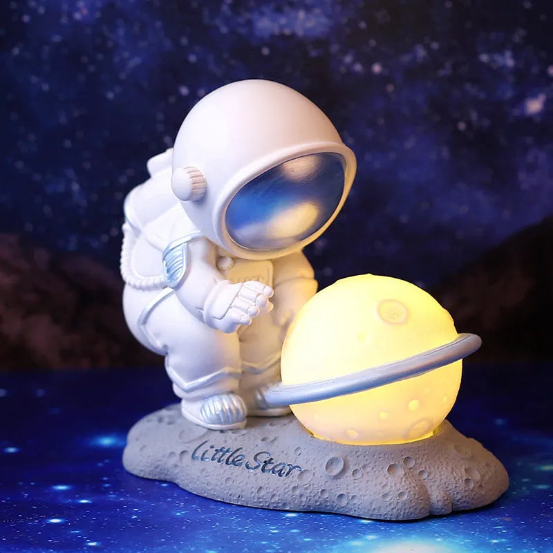 Cartoon spaceman resin night light ornament on a bedroom table with built-in battery