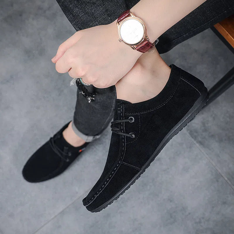 Men's black slip-on loafers with soft sole, round toe, and stitching detail on a neutral background