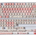 Pink PBT key cap with fragrant pig design on all five sides, shown with keycap puller tool