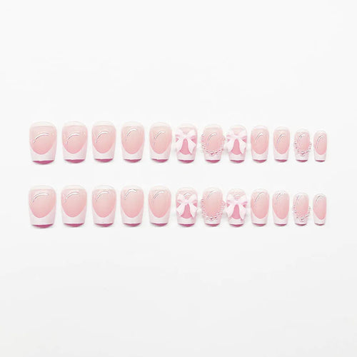Artificial press-on nails with French manicure style showing bow patterns and tulip designs on short European square nails