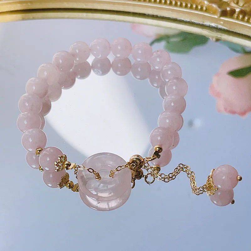 Pink crystal peace buckle bracelet with safety closure for women, adjustable design