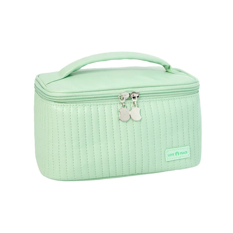 Open-top cake-shaped women's makeup bag in PU leather, shown in a soft solid colour.