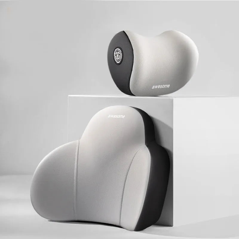 Black and grey memory foam car headrest pillow and lumbar support pillow on a car seat.