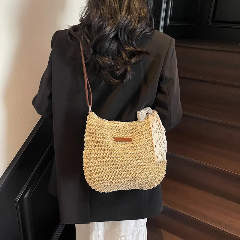 Women's woven straw messenger bag with hollowed design and single shoulder strap in khaki colour