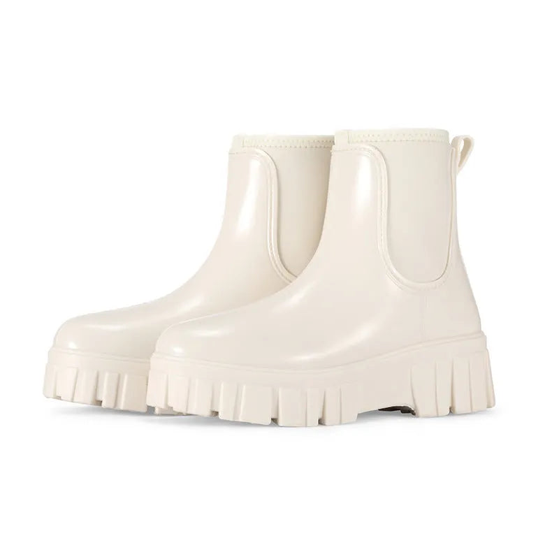 A pair of low tube PVC rain boots with a flat heel, shown in a solid colour on a white background.