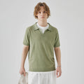 Man's short-sleeved knitted polo t-shirt in a solid colour on a hanger.