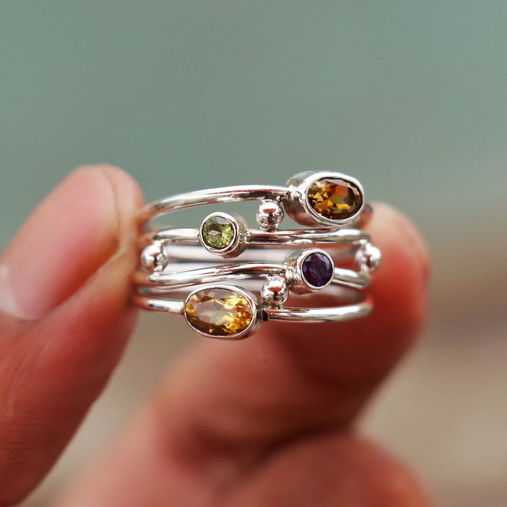 Silver bohemian diamond studded hollow copper ring with geometric ellipse shape on plain background